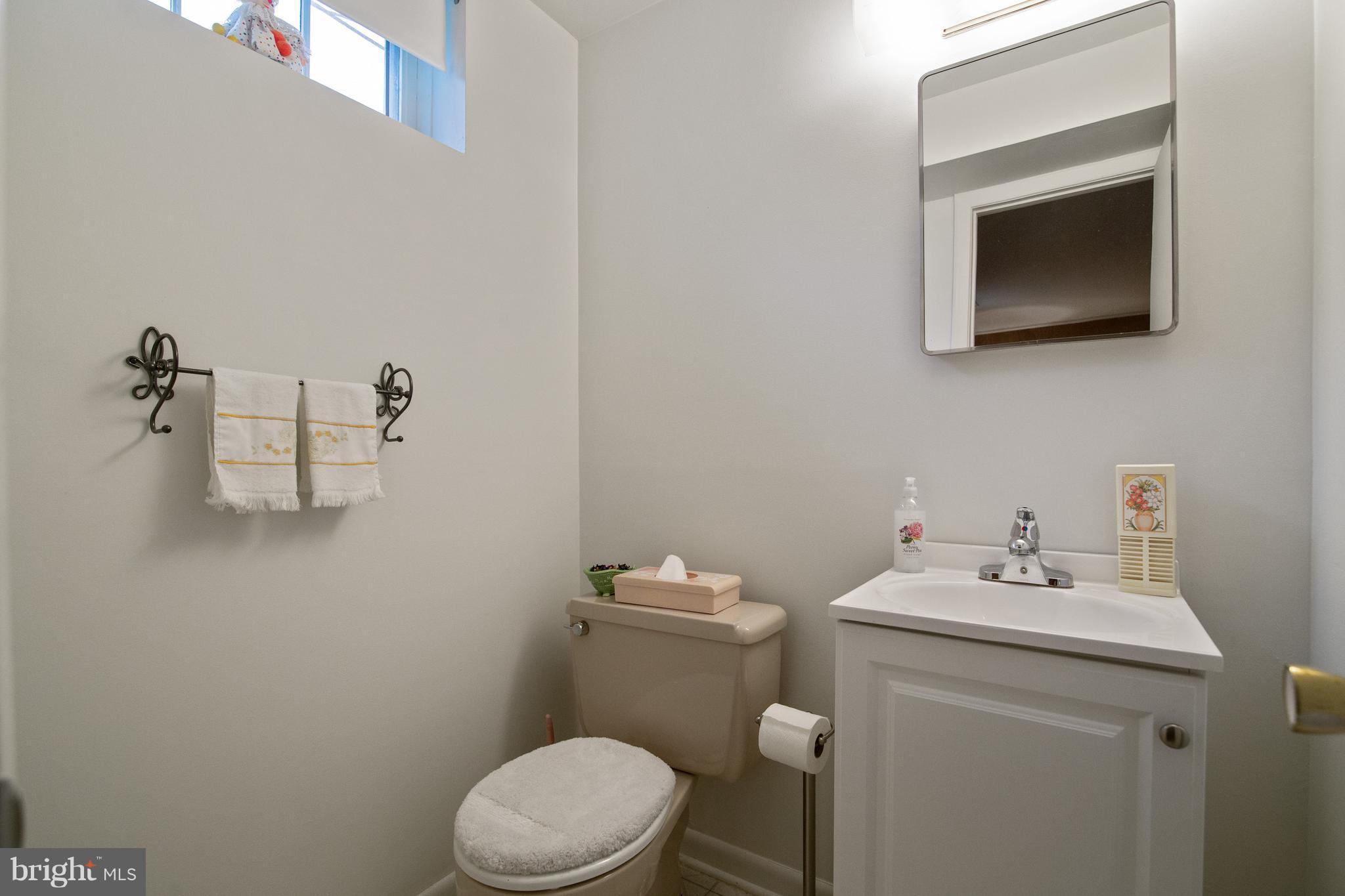 7504 Shelowood Road Baltimore, MD 21208 - Photo 23 of 29 a bathroom with a sink a toilet and mirror