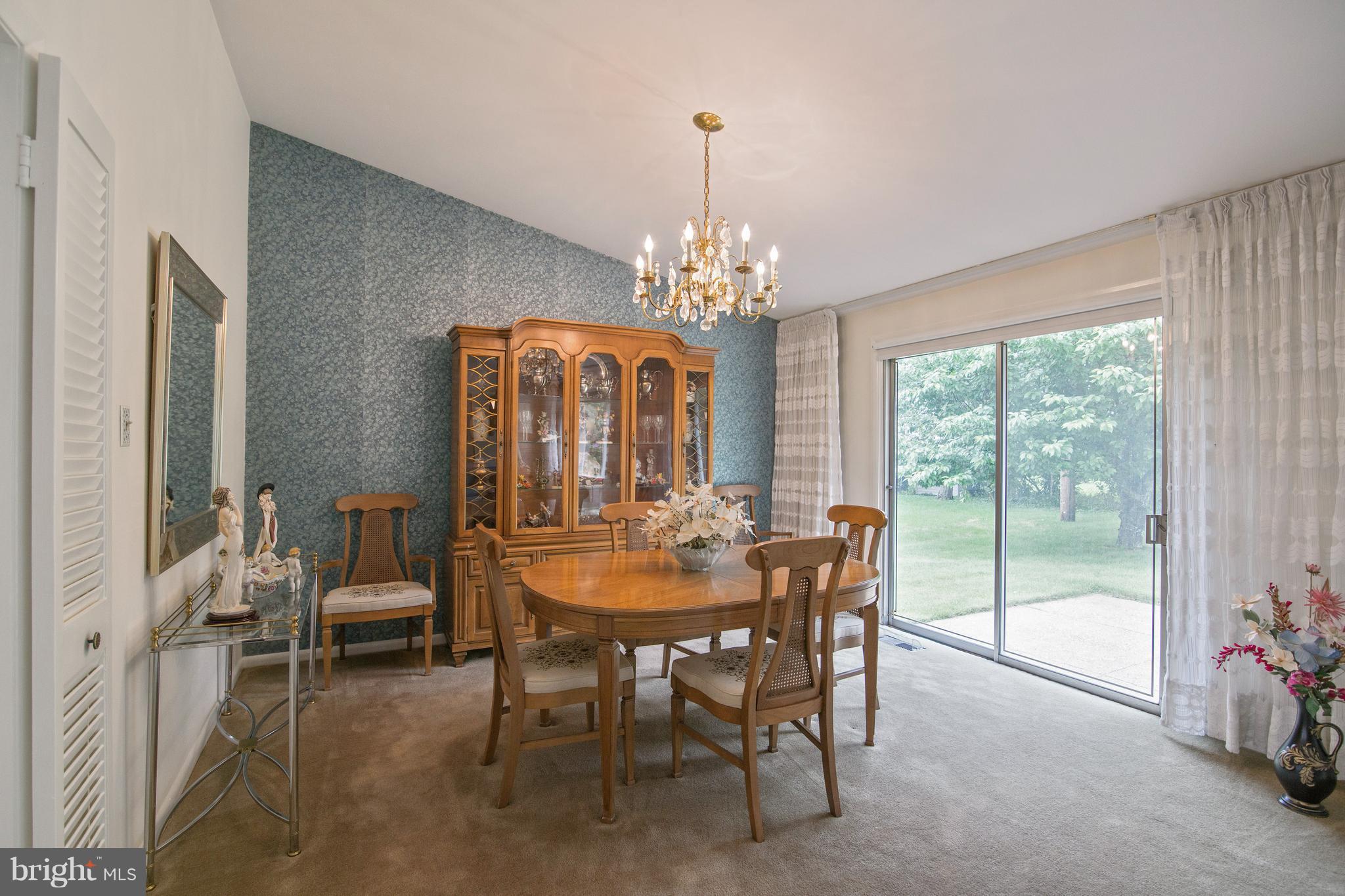 7504 Shelowood Road Baltimore, MD 21208 - Photo 8 of 29 a view of a dining room with furniture and chandelier