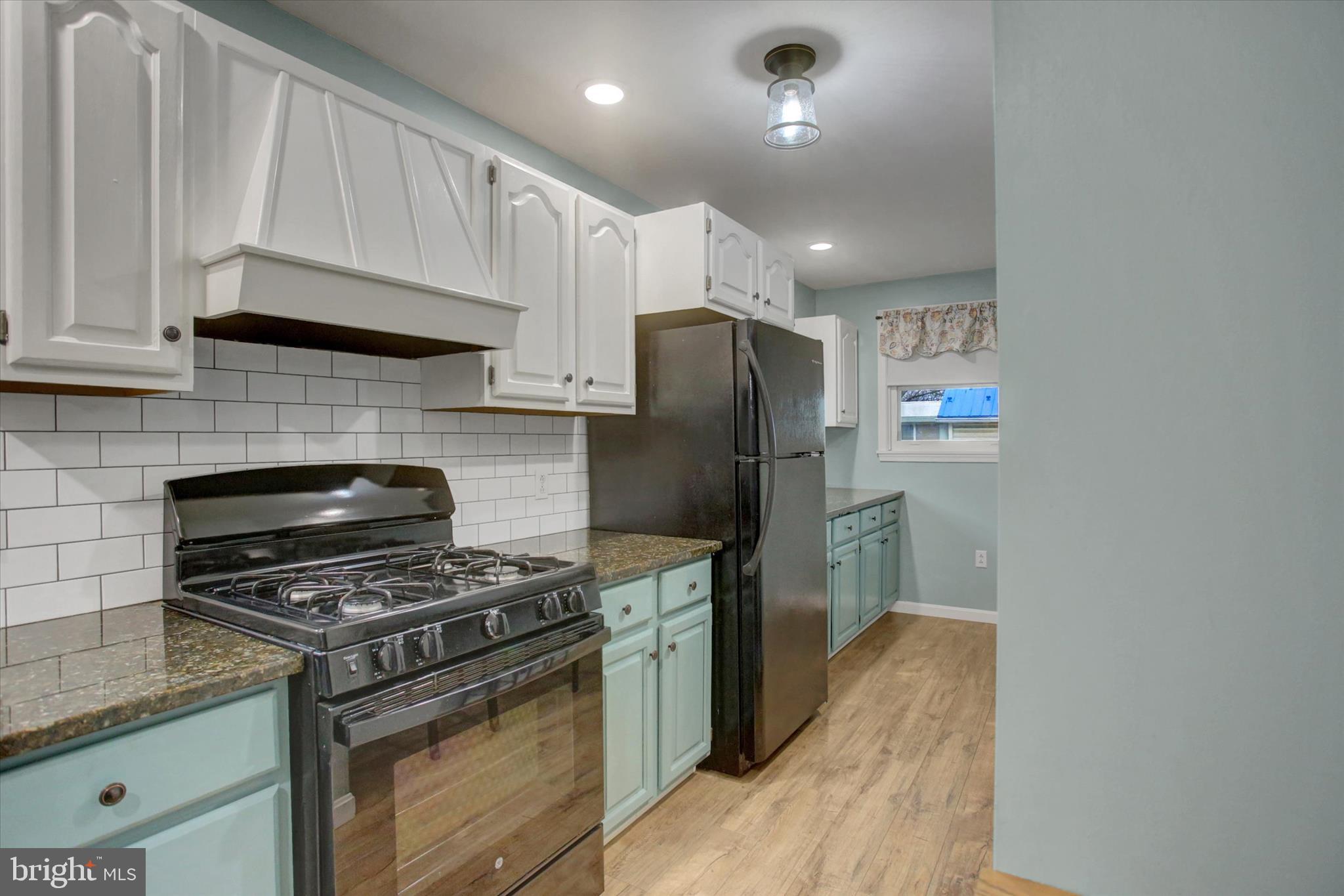 615 Walnut Bottom Road Shippensburg, PA 17257 - Photo 19 of 47 a kitchen with stainless steel appliances a refrigerator a stove a sink and a cabinets
