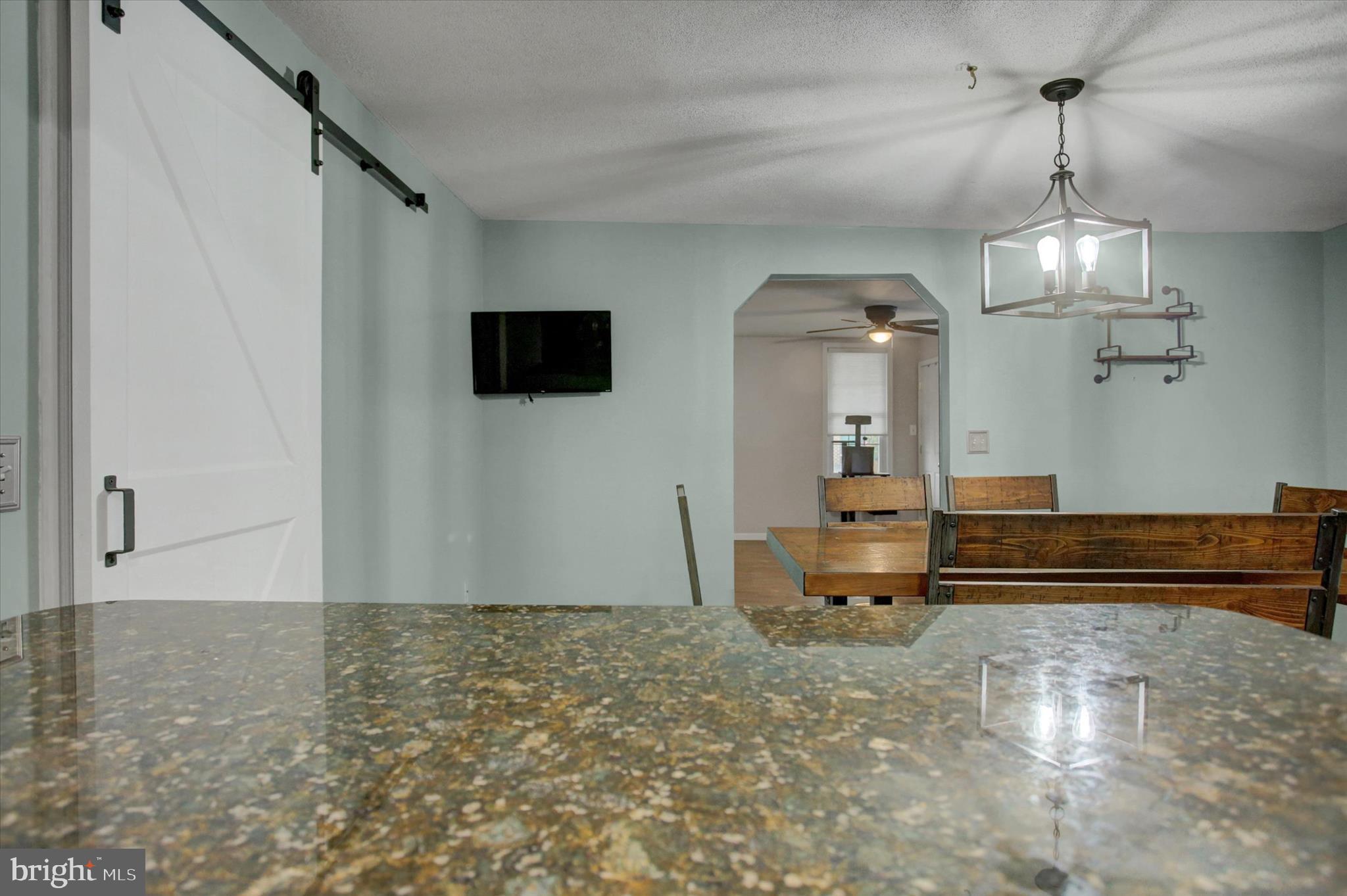 615 Walnut Bottom Road Shippensburg, PA 17257 - Photo 24 of 47 en empty room with wooden floor and ceiling fan