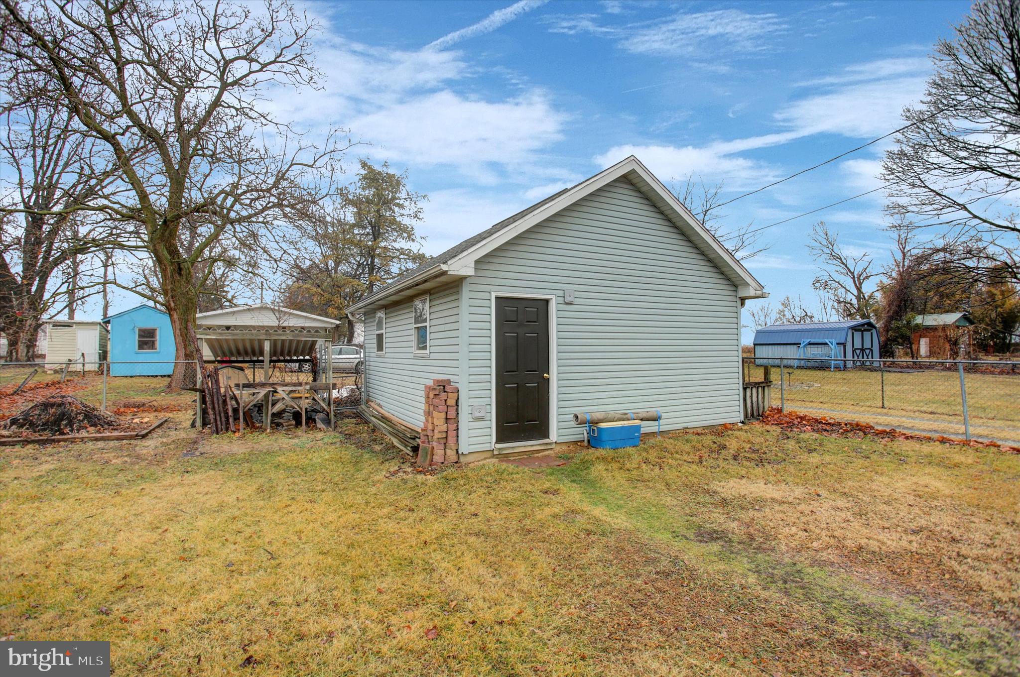 615 Walnut Bottom Road Shippensburg, PA 17257 - Photo 43 of 47 a view of a house with table and chairs under an umbrella