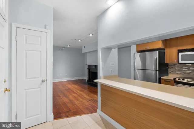 a view of hallway with stairs and wooden floor