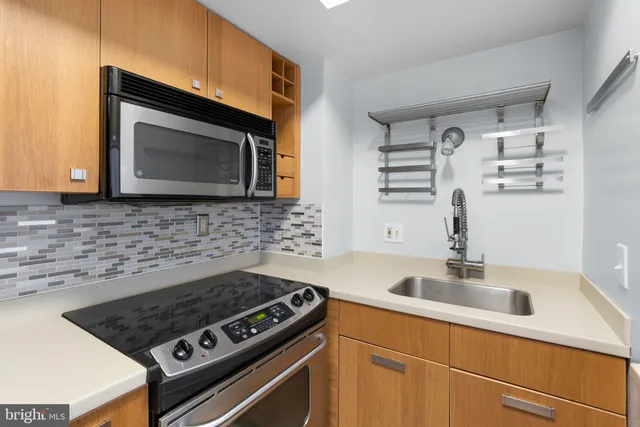 a kitchen with cabinets and appliances