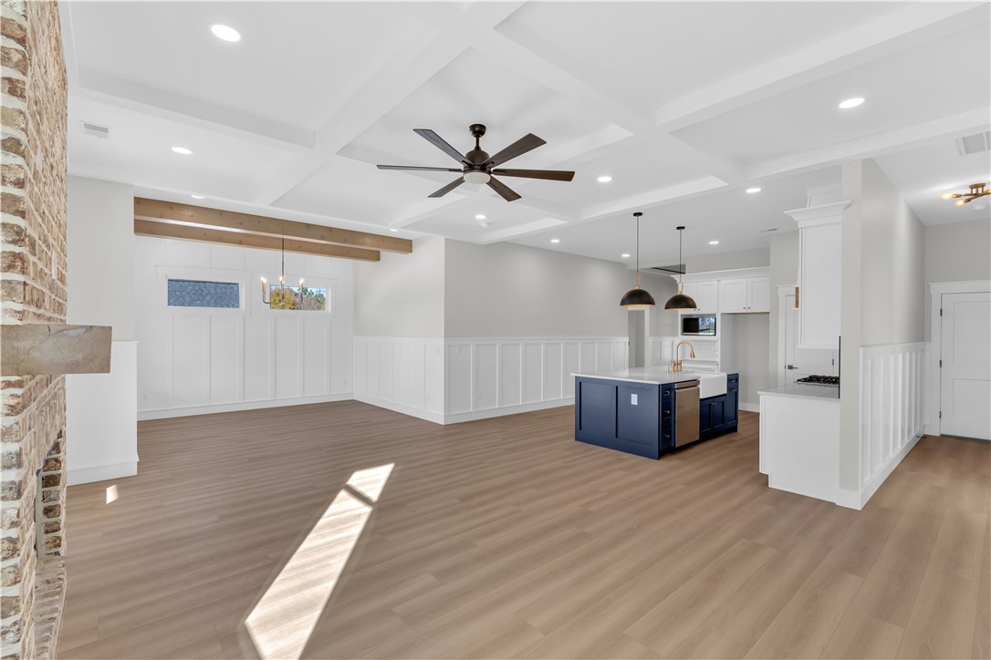 516 Lakeside Drive Anderson, SC 29621 - Photo 19 of 32 A well-lit open-concept living space with hardwood flooring and a stylish kitchen island.