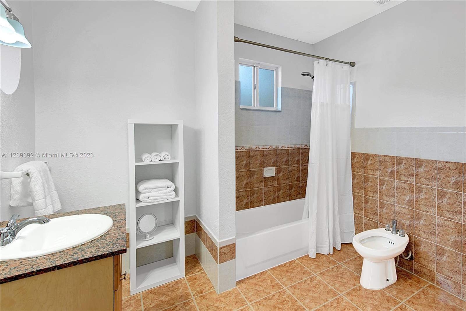 100 Southwest 26th Road Miami, FL 33129 - Photo 15 of 34 a bathroom with a granite countertop sink toilet and shower