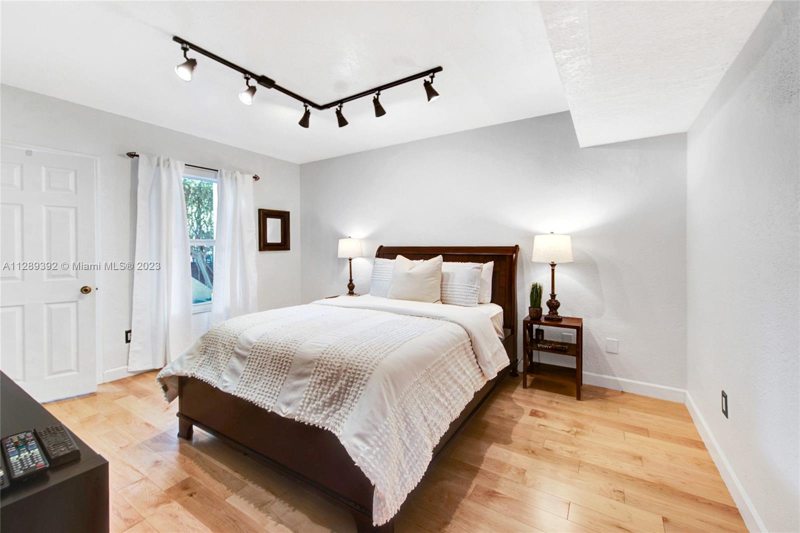 100 Southwest 26th Road Miami, FL 33129 - Photo 16 of 34 a bedroom with a bed and wooden floor