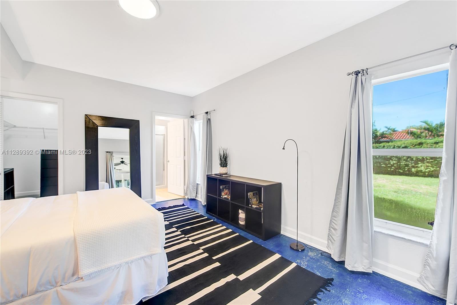 100 Southwest 26th Road Miami, FL 33129 - Photo 19 of 34 a bedroom with a bed and wooden floor