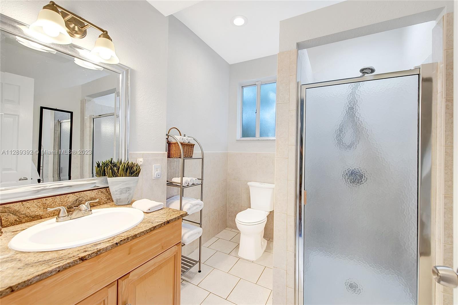 100 Southwest 26th Road Miami, FL 33129 - Photo 20 of 34 a bathroom with a granite countertop sink toilet and shower