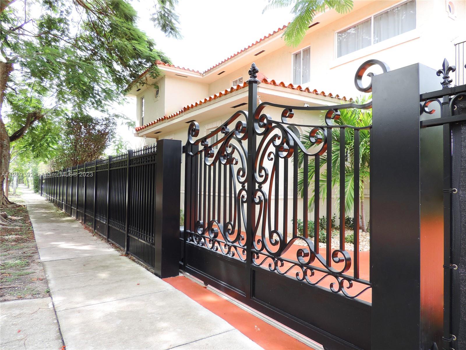 100 Southwest 26th Road Miami, FL 33129 - Photo 2 of 34 a view of a street with wooden fence