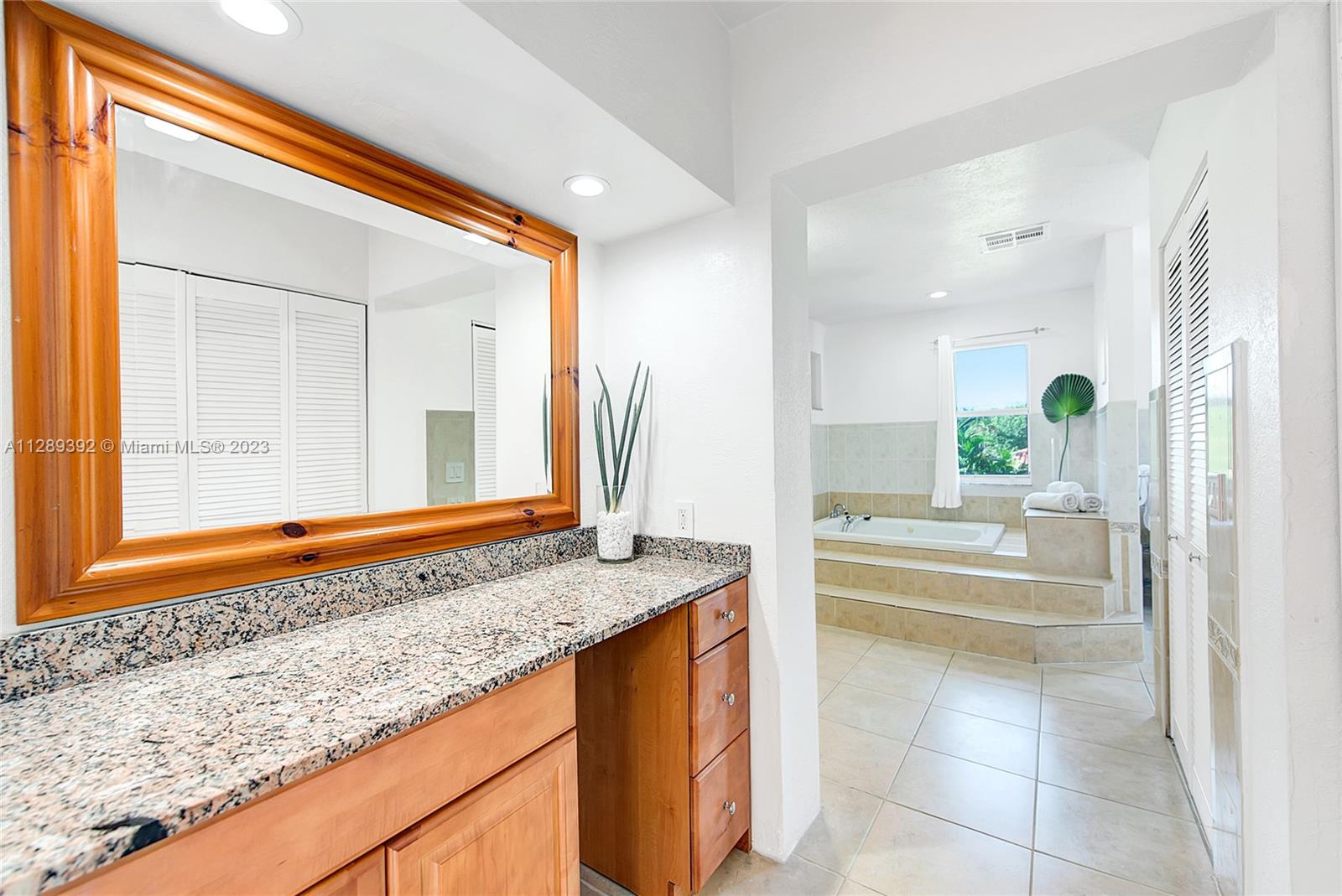 100 Southwest 26th Road Miami, FL 33129 - Photo 23 of 34 a bathroom with a granite countertop sink and a bathtub