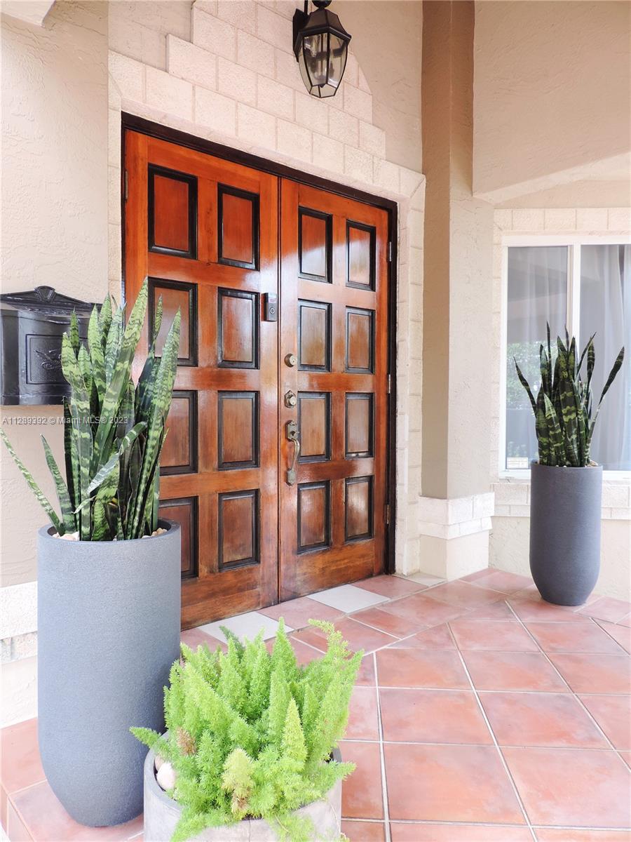 100 Southwest 26th Road Miami, FL 33129 - Photo 3 of 34 a view of front door of house and potted plant