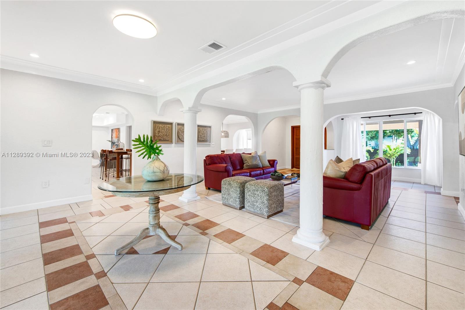 100 Southwest 26th Road Miami, FL 33129 - Photo 5 of 34 a living room with furniture and a chandelier