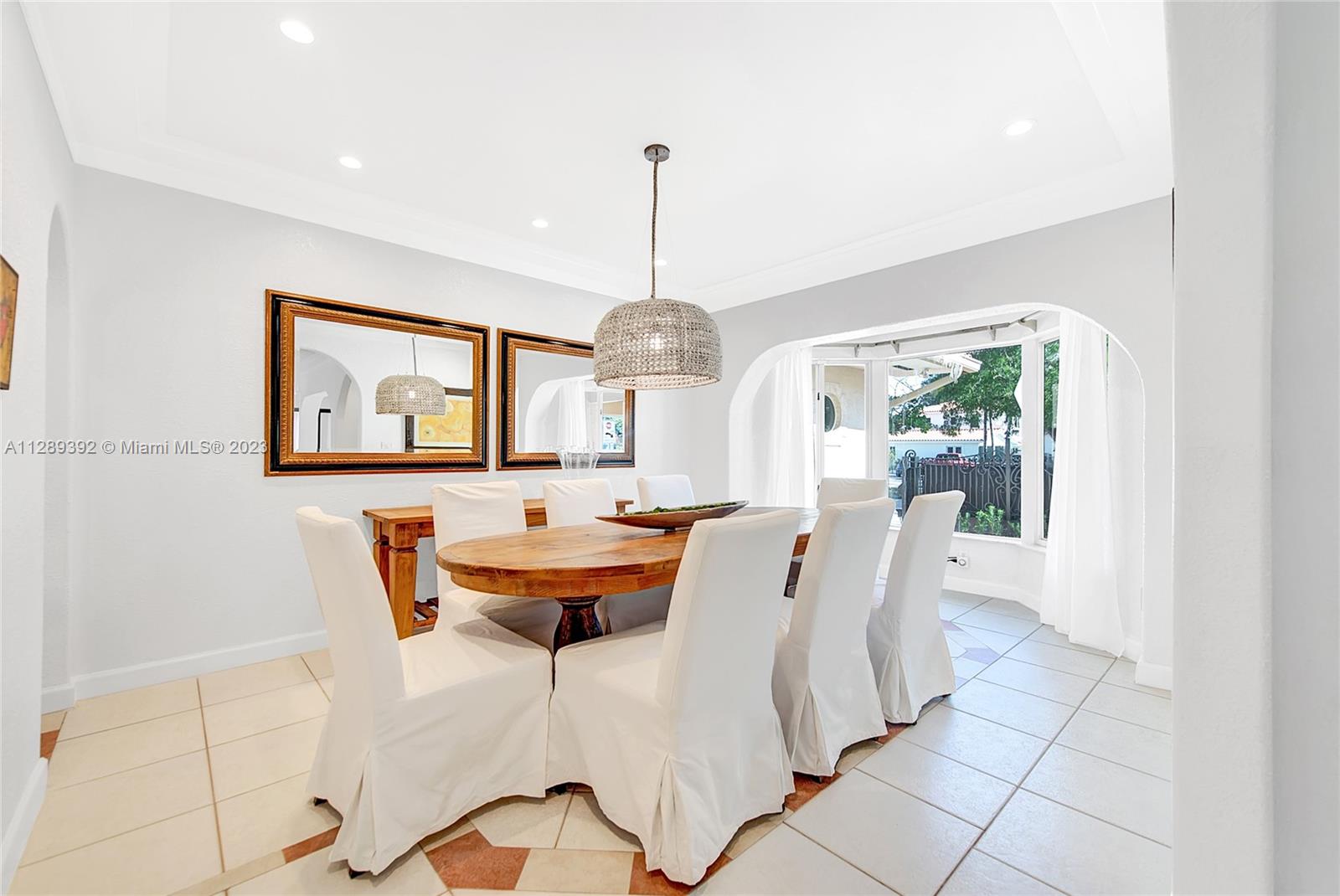 100 Southwest 26th Road Miami, FL 33129 - Photo 7 of 34 a dining room with furniture a chandelier and window