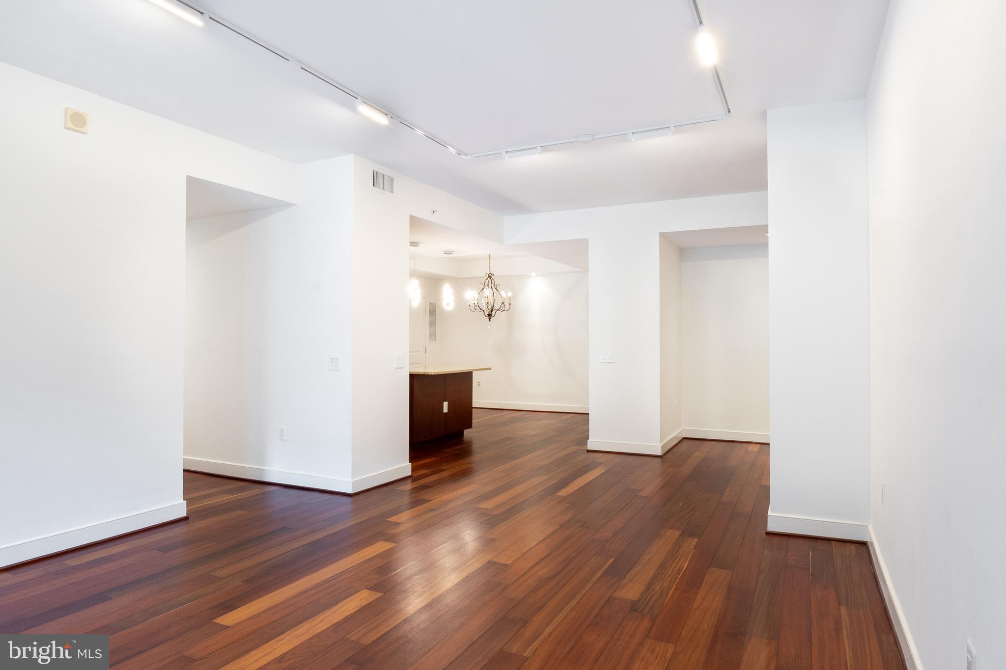 2425 L Street Northwest, Unit 431 Washington, DC 20037 - Photo 12 of 30 a view of an empty room with wooden floor