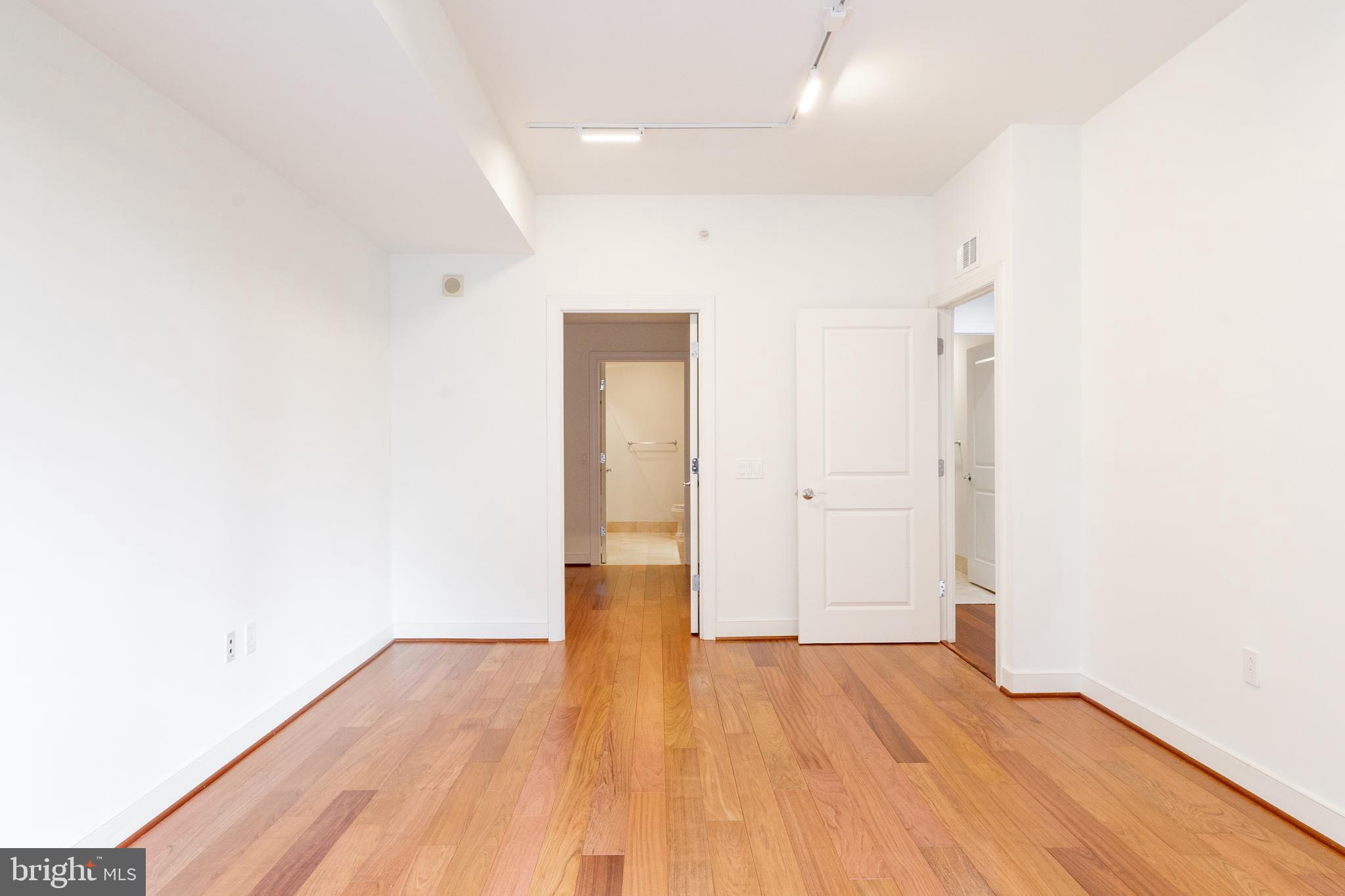 2425 L Street Northwest, Unit 431 Washington, DC 20037 - Photo 16 of 30 a view of an empty room with wooden floor