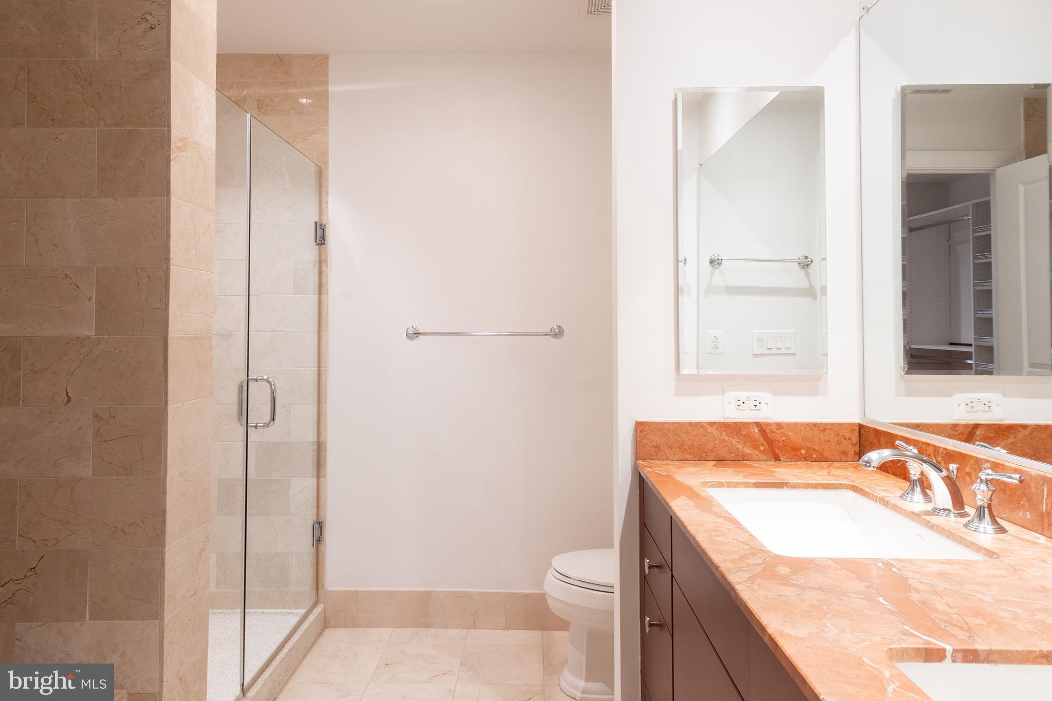 2425 L Street Northwest, Unit 431 Washington, DC 20037 - Photo 18 of 30 a bathroom with a granite countertop sink a toilet and shower