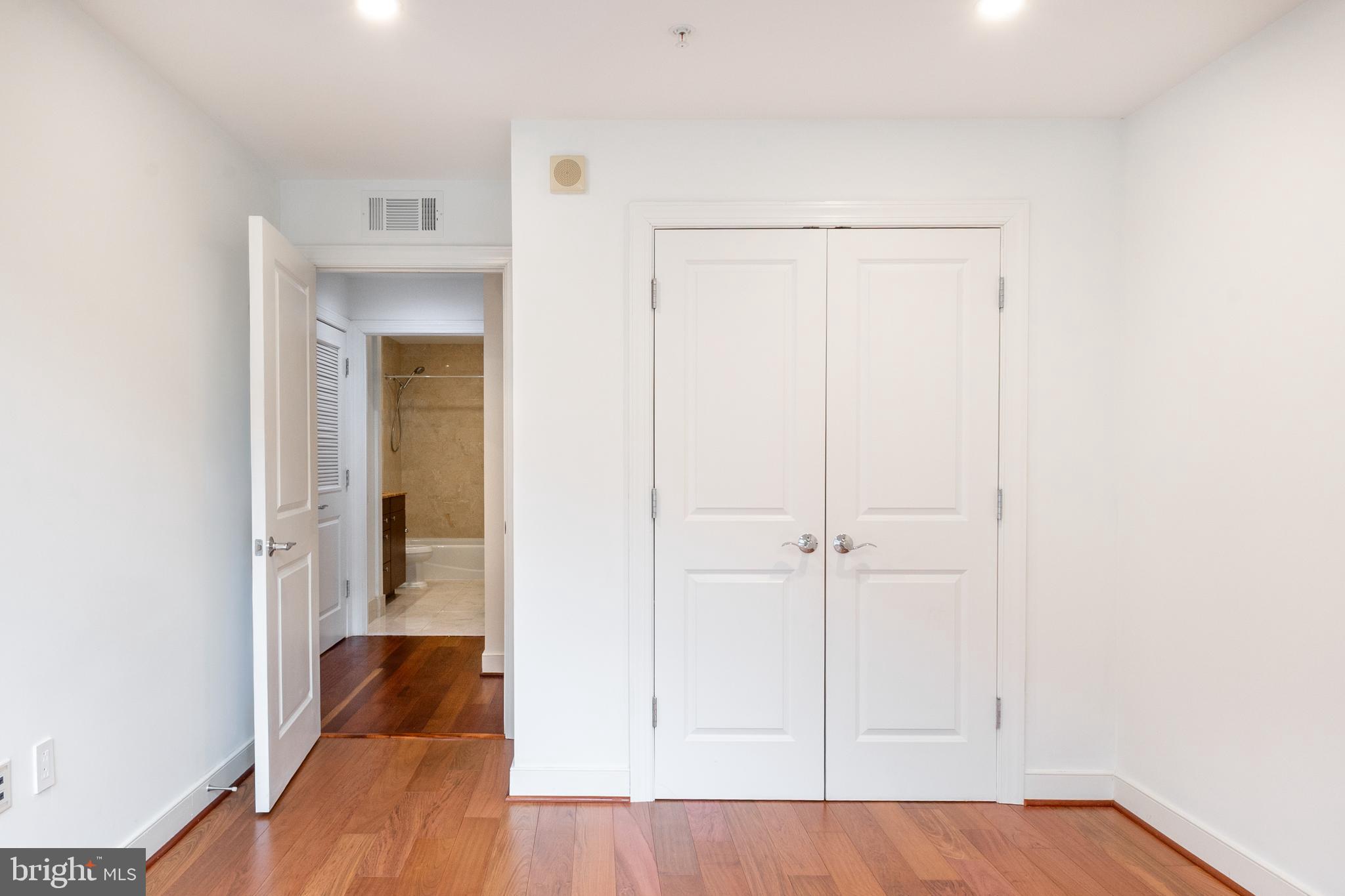 2425 L Street Northwest, Unit 431 Washington, DC 20037 - Photo 21 of 30 an empty room with wooden floor and closet
