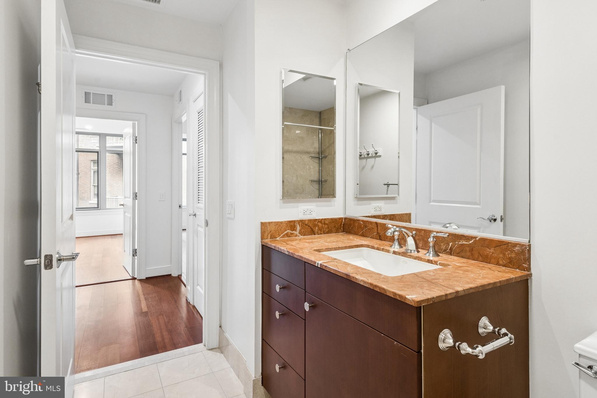 2425 L Street Northwest, Unit 431 Washington, DC 20037 - Photo 22 of 30 a bathroom with a sink and a mirror