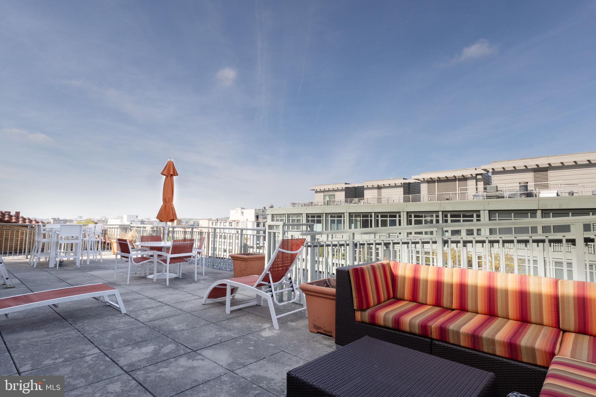 2425 L Street Northwest, Unit 431 Washington, DC 20037 - Photo 28 of 30 a roof deck with a table and chairs