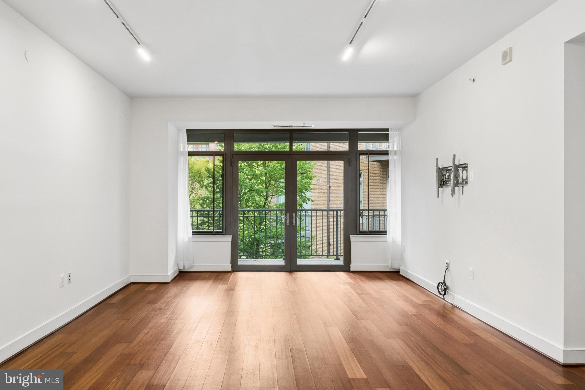 2425 L Street Northwest, Unit 431 Washington, DC 20037 - Photo 5 of 30 wooden floor in an empty room with a window