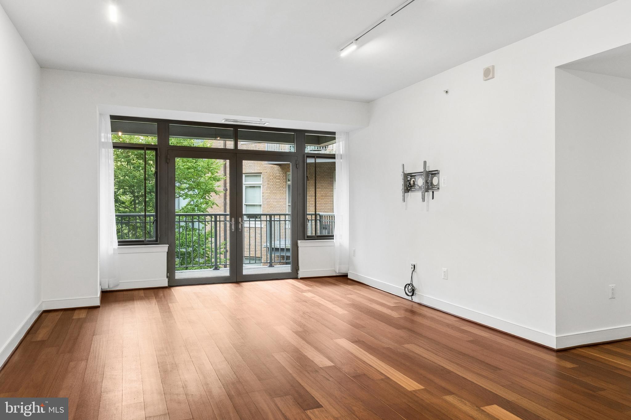 2425 L Street Northwest, Unit 431 Washington, DC 20037 - Photo 6 of 30 a view of an empty room with wooden floor and a window