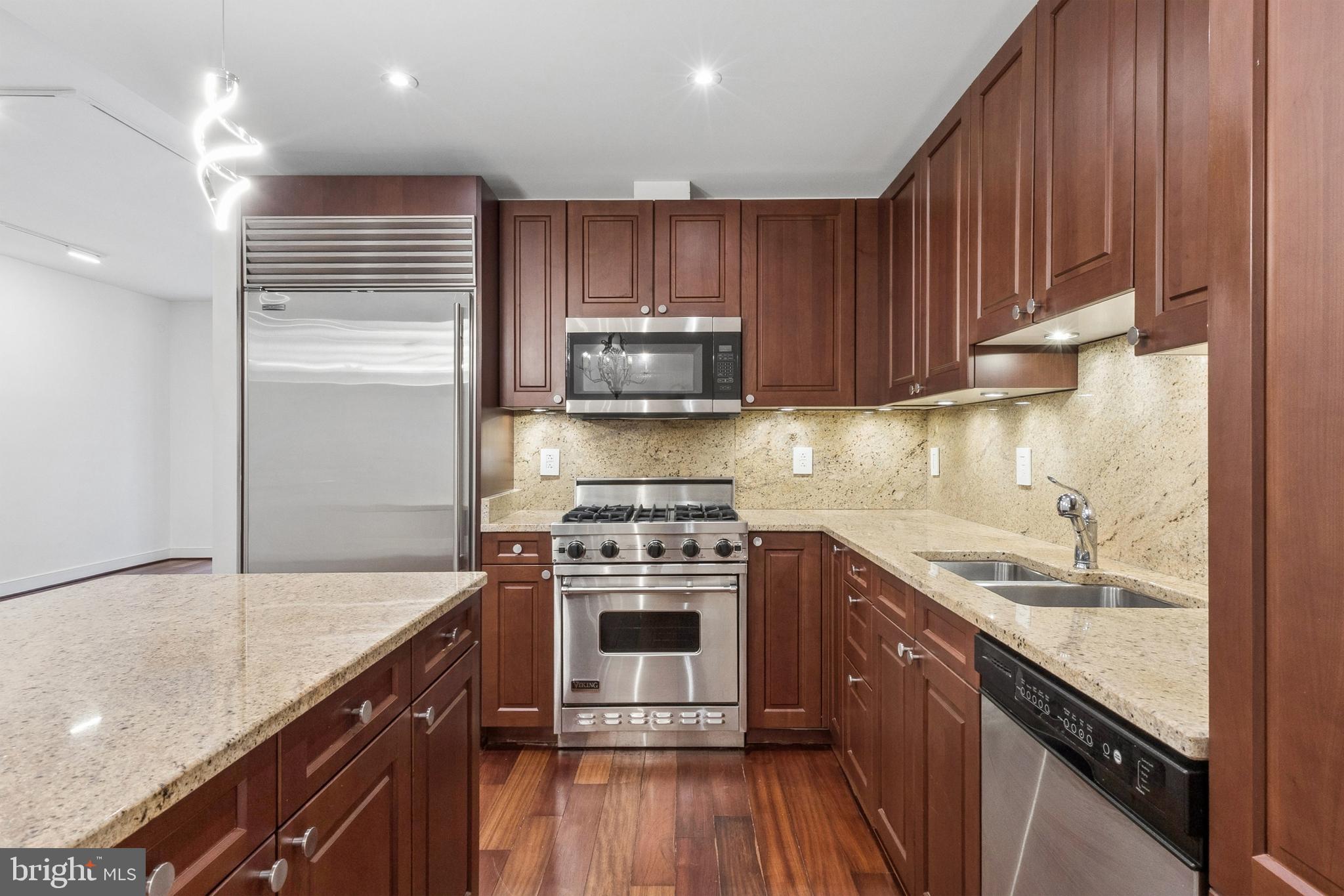 2425 L Street Northwest, Unit 431 Washington, DC 20037 - Photo 10 of 30 a kitchen with a sink stove top oven and cabinets