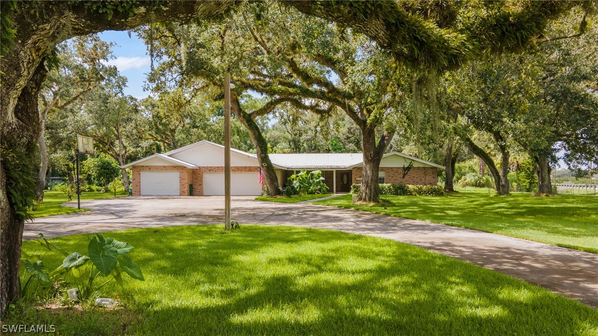 2340 Old N River Road LaBelle, FL 33935 - Photo 1 of 28 a house is sitting in middle od the grass
