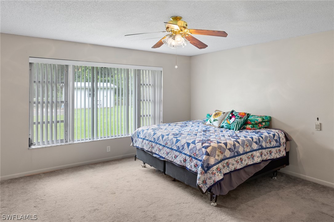 2340 Old N River Road LaBelle, FL 33935 - Photo 11 of 28 a bed sitting in a bedroom next to a window