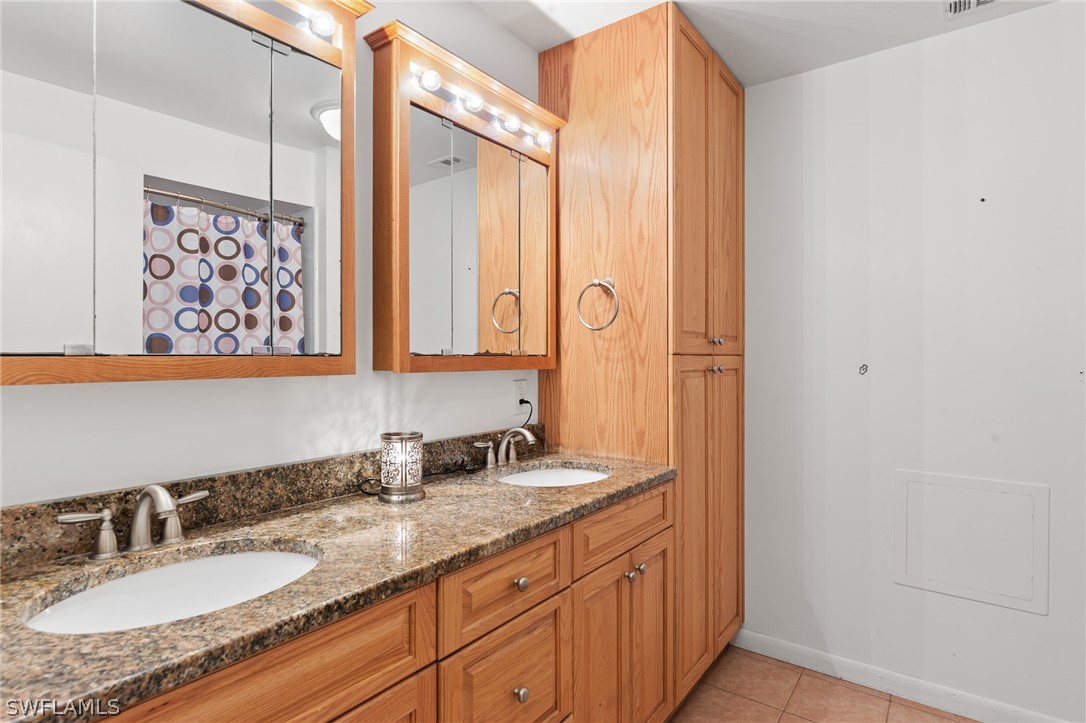 2340 Old N River Road LaBelle, FL 33935 - Photo 16 of 28 a bathroom with double sink and a mirror