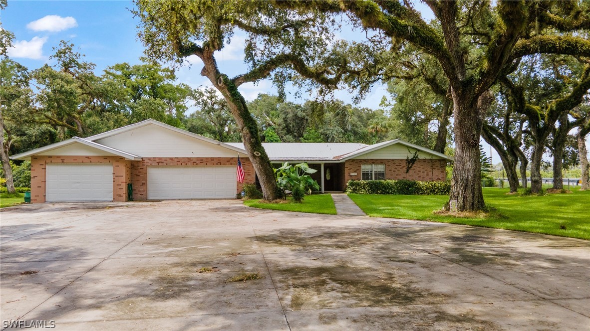 2340 Old N River Road LaBelle, FL 33935 - Photo 22 of 28 a front view of house with yard and green space