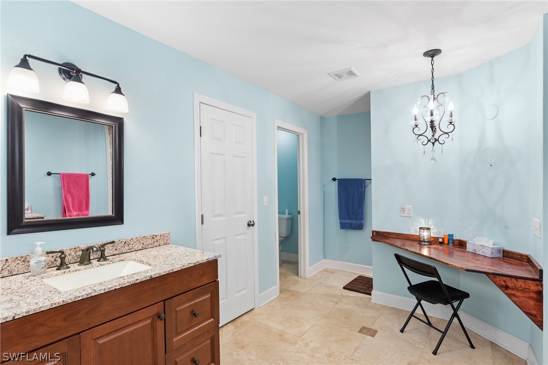 2340 Old N River Road LaBelle, FL 33935 - Photo 9 of 28 a spacious bathroom with a granite countertop sink a mirror and a shower