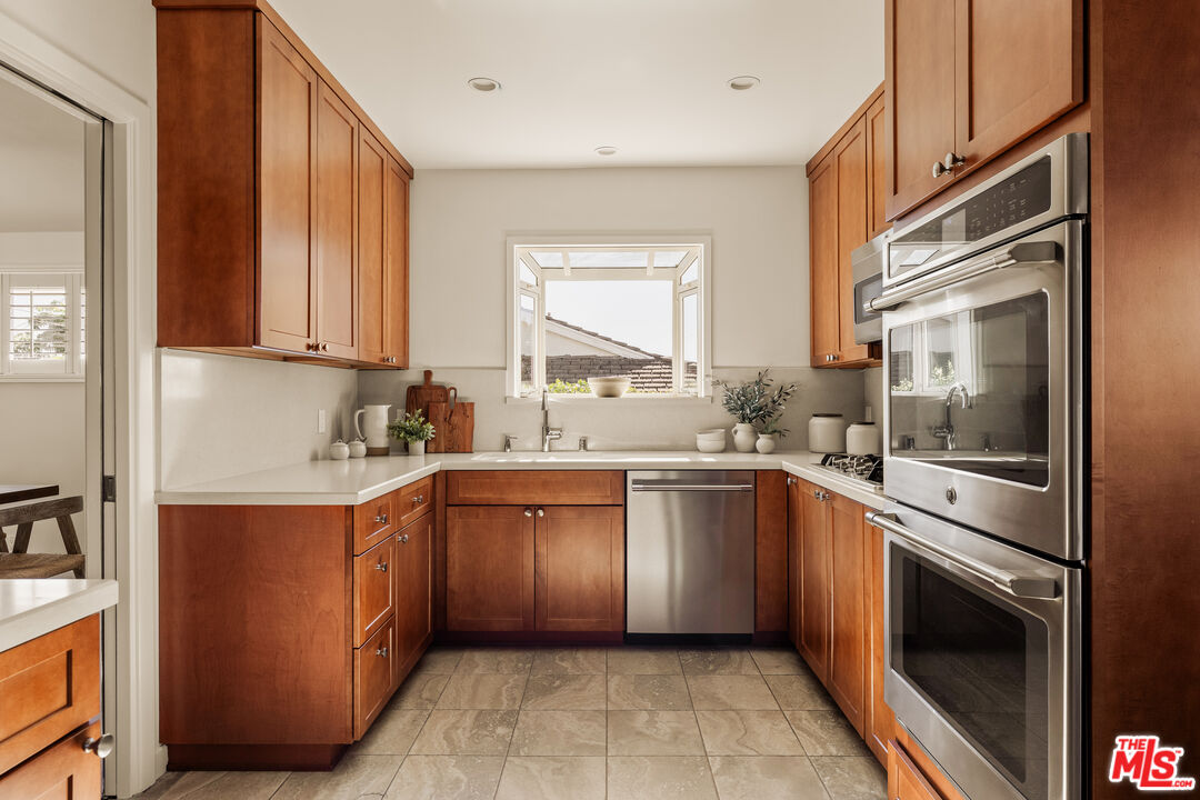 5124 South Corning Avenue Los Angeles, CA 90056 - Photo 13 of 30 a kitchen with stainless steel appliances granite countertop a sink stove and refrigerator