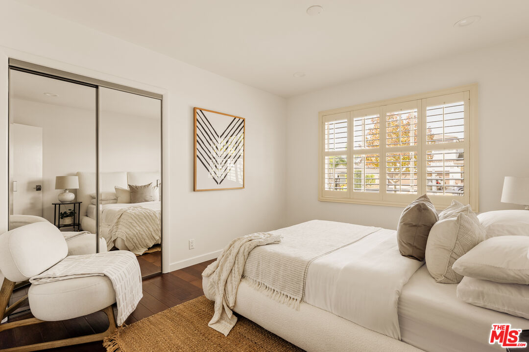 5124 South Corning Avenue Los Angeles, CA 90056 - Photo 19 of 30 a bedroom with a bed and wooden floor