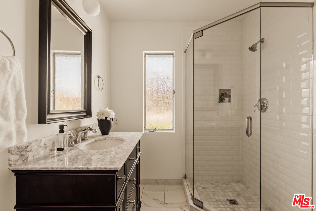 5124 South Corning Avenue Los Angeles, CA 90056 - Photo 20 of 30 a bathroom with a granite countertop sink shower and a mirror