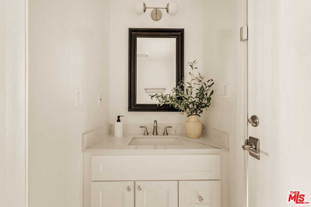 5124 South Corning Avenue Los Angeles, CA 90056 - Photo 27 of 30 a bathroom with a sink and a mirror