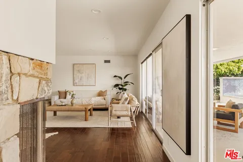 a view of a kitchen area with furniture and wooden floor