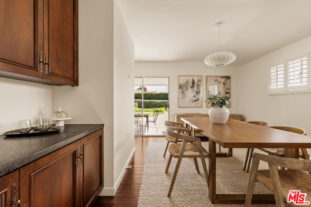 5124 South Corning Avenue Los Angeles, CA 90056 - Photo 10 of 30 a view of a kitchen area with furniture and wooden floor