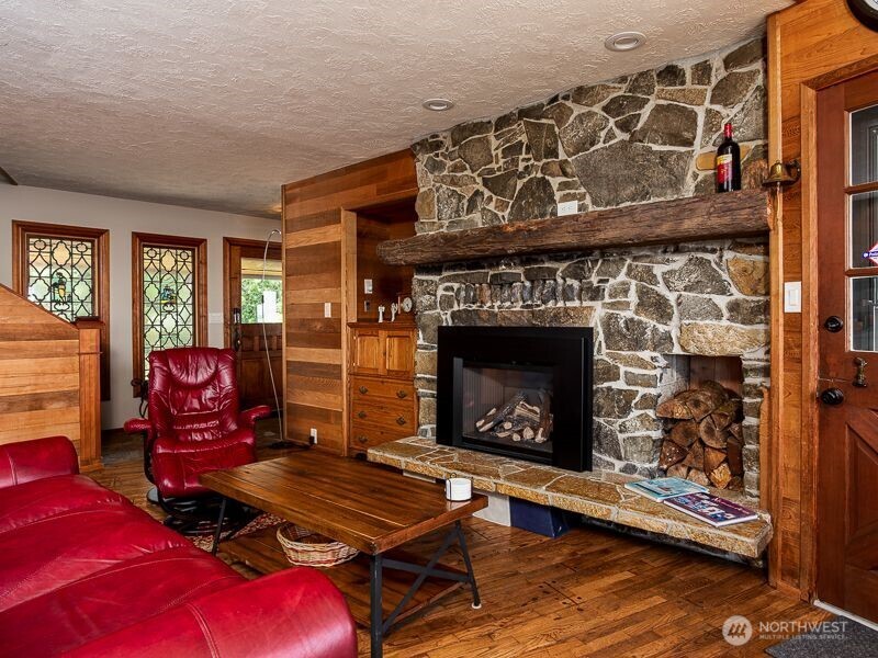633 Highway 101 Chinook, WA 98614 - Photo 11 of 39 a living room with furniture a flat screen tv and a fireplace