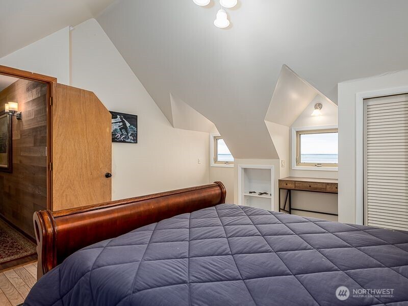 633 Highway 101 Chinook, WA 98614 - Photo 22 of 39 a bedroom with a bed and a window