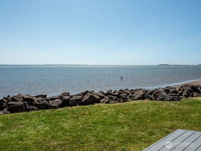 a view of a roof deck with chair and wooden floor