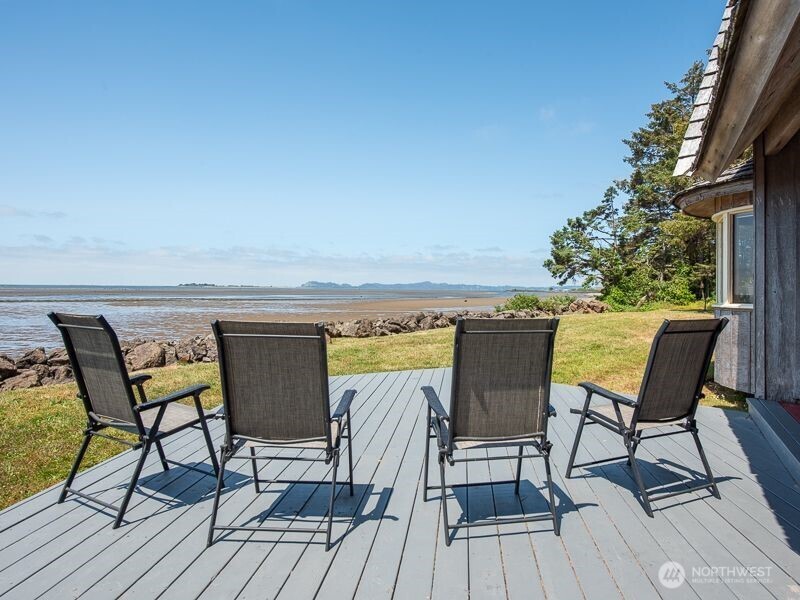 633 Highway 101 Chinook, WA 98614 - Photo 5 of 39 a view of a chairs and table on wooden deck with a dining space