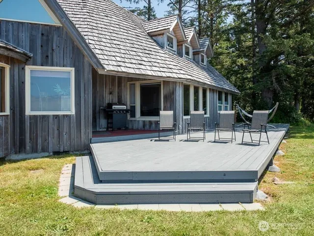 a view of a house with backyard porch and sitting area