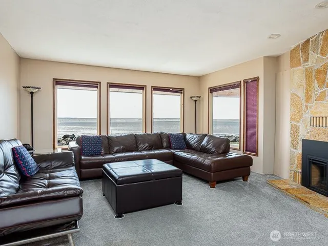 a living room with furniture and large windows
