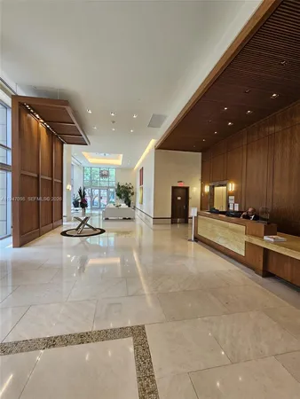 a lobby with furniture and a large mirror
