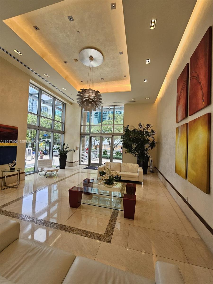 1060 Brickell Avenue, Unit 1917 Miami, FL 33131 - Photo 2 of 24 a kitchen with sink refrigerator and large window