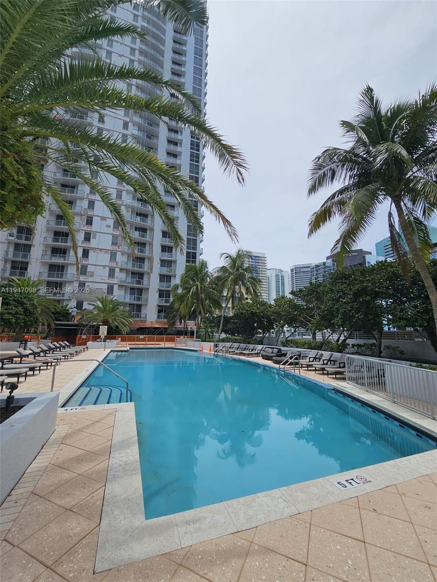 1060 Brickell Avenue, Unit 1917 Miami, FL 33131 - Photo 24 of 24 a view of a swimming pool with a lounge chairs