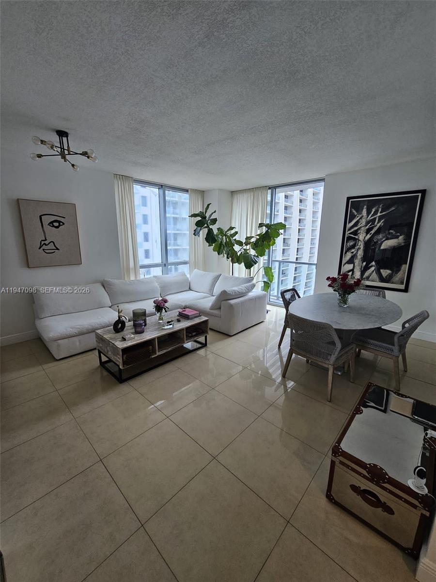 1060 Brickell Avenue, Unit 1917 Miami, FL 33131 - Photo 6 of 24 a living room with furniture gym equipment and a window