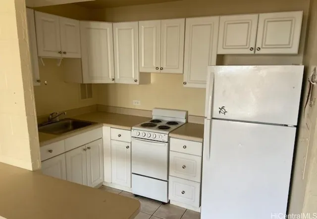 a white refrigerator freezer sitting inside of a kitchen