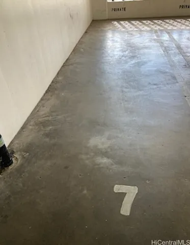 a view of a refrigerator in an empty room