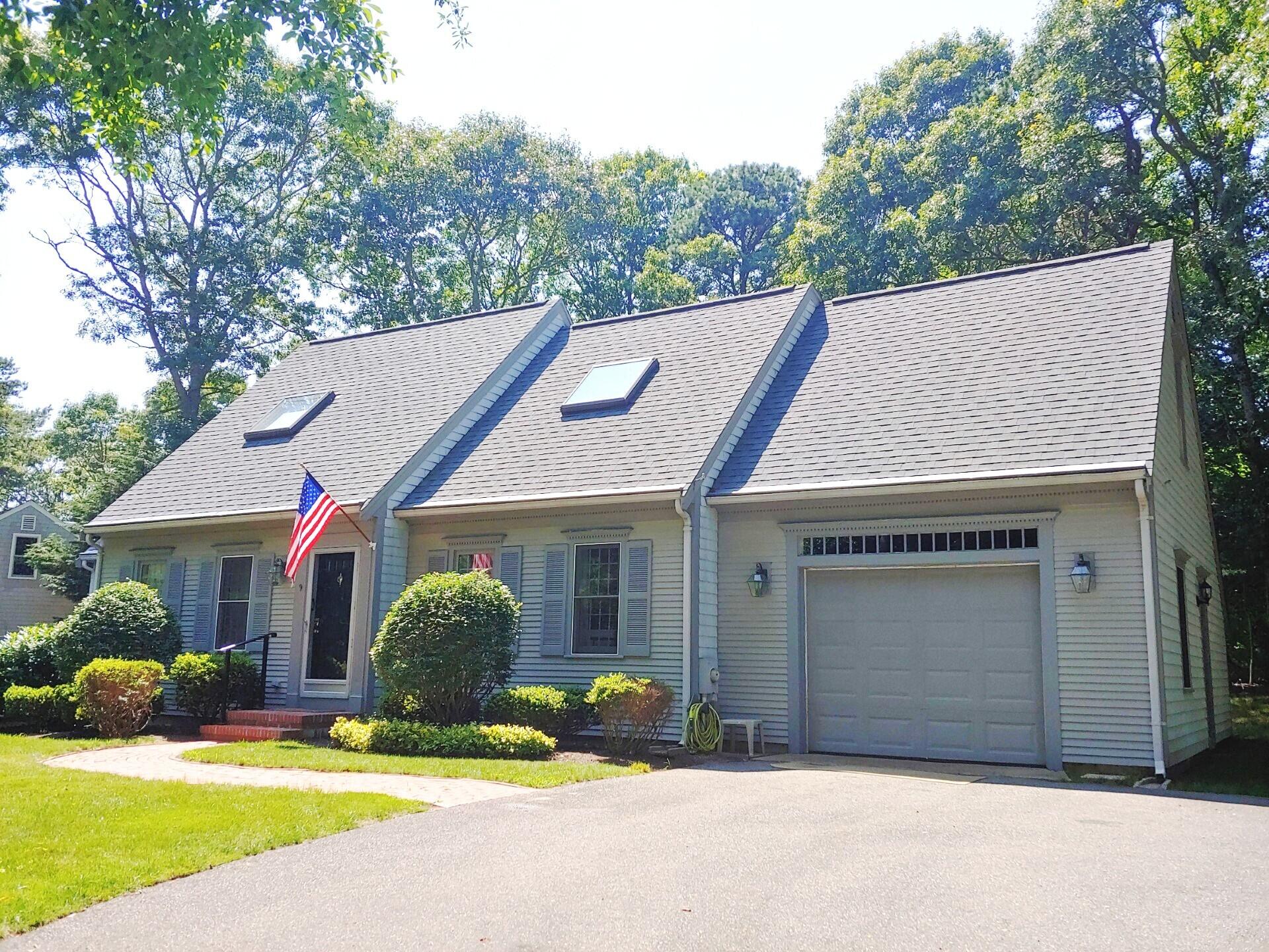 9 Rainbow Drive Centerville, MA 02632 - Photo 1 of 49 a front view of a house with yard and glass windows